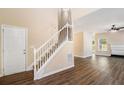 Inviting entryway features hardwood floors, a staircase with white railing, and views into the living spaces at 45 Chapman Way, Covington, GA 30016