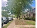 Neighborhood street view with neatly kept lawns, sidewalks and parked cars, perfect for families at 6158 Thorncrest Dr, Tucker, GA 30084