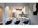 Charming kitchen with breakfast bar, white cabinetry, stainless steel appliances, and modern finishes at 2277 Peachtree Ne Rd # 507, Atlanta, GA 30309