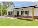 Attractive house featuring a covered front porch with wood pillars and stone accents at 1765 Harmony Rd, Temple, GA 30179