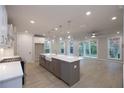 Kitchen with white cabinets, stainless appliances, large island with sink, and a sliding glass door at 134 Wards Crossing Way # 17, Johns Creek, GA 30022