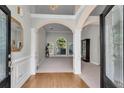 Welcoming foyer with high ceilings, arched doorways, hardwood accents, and natural light at 169 Twickenham Trce, Suwanee, GA 30024