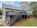Rear exterior showcasing a large wooden deck and landscaped backyard at 65 Indian Springs Ne Dr, Rydal, GA 30171