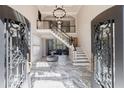 Grand foyer with marble floors, staircase, chandelier, and a view to the living area at 9105 Old Southwick Pass, Johns Creek, GA 30022