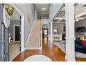 Grand foyer with hardwood floors, staircase, and an open view into the living area at 4745 Prather Farm Cir, Cumming, GA 30040