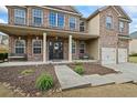 Charming front entrance with a covered porch, decorative columns, and beautiful landscaping at 4745 Prather Farm Cir, Cumming, GA 30040