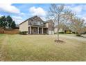 Spacious two-story home with a large front yard and a welcoming covered front porch at 4745 Prather Farm Cir, Cumming, GA 30040