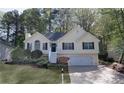 Charming home with landscaped front yard, attached garage, and stairway entry at 3027 Clove Tree Ln, Woodstock, GA 30189