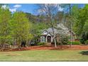 Beautifully landscaped front yard highlighting a classic brick home with a welcoming entrance at 423 Morgan Falls Chase, Canton, GA 30114