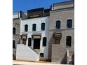 Exterior view of new construction townhomes with white painted brick at 4812 Moonview Ln # 4, Sugar Hill, GA 30518