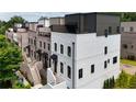 New townhomes featuring brick and painted exteriors with black window frames and awning-covered entryways at 4812 Moonview Ln # 4, Sugar Hill, GA 30518