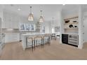 Modern kitchen features white cabinets, an island with bar seating, and accent lighting at 4812 Moonview Ln # 4, Sugar Hill, GA 30518