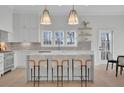 Bright kitchen featuring an island with seating, stainless appliances, and floating shelves at 4812 Moonview Ln # 4, Sugar Hill, GA 30518