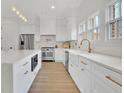 Elegant kitchen with stainless steel appliances, white cabinets, quartz countertops, and a large island at 4812 Moonview Ln # 4, Sugar Hill, GA 30518