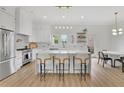 Bright, open kitchen featuring white cabinets, a large island, and modern lighting fixtures at 4812 Moonview Ln # 4, Sugar Hill, GA 30518