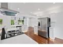 Modern kitchen with stainless steel appliances, quartz countertops, and hardwood floors at 733 Pegg Sw Rd, Atlanta, GA 30315