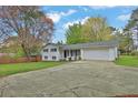 Ranch-style home with a well-manicured front yard and a long driveway at 1531 Piedmont Ne Rd, Marietta, GA 30066