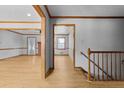 Inviting home hallway with light wood floors, staircase and trim, leading to adjacent rooms at 2003 Graystone Pkwy, Grayson, GA 30017
