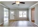 Spacious living area featuring hardwood floors, crown molding, and an abundance of natural light at 3855 Shelleydale Dr, Powder Springs, GA 30127
