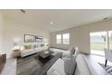 Bright living room features neutral decor, plush seating, and large windows for an inviting atmosphere at 7763 Sudbury Cir, Covington, GA 30014