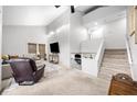 Bright living room with a staircase, recessed lighting, and comfortable seating arrangement at 8885 N Mount Dr, Johns Creek, GA 30022