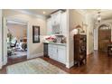 Hallway area with wine rack, leading to bedroom and wooden front door at 115 Batten Board Way Way, Woodstock, GA 30189