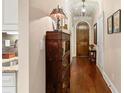 Elegant hallway features hardwood floors and a decorative chandelier at 115 Batten Board Way Way, Woodstock, GA 30189