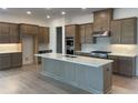 New kitchen featuring an island, stainless appliances, ample cabinet space, and granite countertops at 250 Mooney Rd, Woodstock, GA 30188