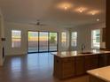 Open-concept living room featuring hardwood floors and sliding glass doors to backyard at 250 Mooney Rd, Woodstock, GA 30188