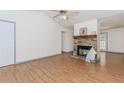 Inviting living room with a stone fireplace, wood-look floors, and abundant natural light for a comfortable living space at 85 Emily Trce, Covington, GA 30016