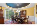 Bright dining room featuring an elegant chandelier, wooden table set, and large windows with wooded views at 104 Kremer Falls Trce, Canton, GA 30114