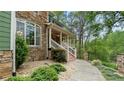Close up of the inviting front porch with stone accents and a well-maintained walkway at 104 Kremer Falls Trce, Canton, GA 30114