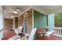Enjoy a relaxing porch swing and seating area on this charming covered front porch at 104 Kremer Falls Trce, Canton, GA 30114