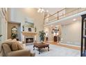 Inviting living room with a stone fireplace, hardwood floors, and large windows for plenty of natural light at 104 Kremer Falls Trce, Canton, GA 30114