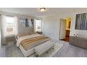 Bright, carpeted bedroom with neutral tones, abundant natural light, and minimalist decor at 7771 Sudbury Cir, Covington, GA 30014