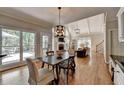 Dining area with cathedral ceiling, hardwood floors, and view of the living room at 9770 Rod Rd, Alpharetta, GA 30022
