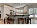 Modern kitchen with granite countertops, white cabinets, and stainless steel appliances at 9770 Rod Rd, Alpharetta, GA 30022