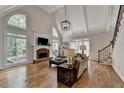 Bright living room featuring high ceilings, large windows, and a cozy fireplace at 9770 Rod Rd, Alpharetta, GA 30022