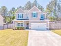 Beautiful home featuring a well-kept lawn, tidy landscaping and gray siding with complementary shutters at 1302 Gardenia Ct, Villa Rica, GA 30180