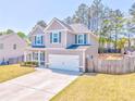 Two-story home featuring a manicured lawn and an attached two-car garage at 1302 Gardenia Ct, Villa Rica, GA 30180