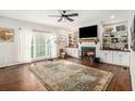 Bright living room with fireplace, built-in shelves, and a large window at 105 Blackberry Ct, Woodstock, GA 30188