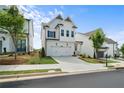 New construction home with white siding, a two-car garage, and manicured landscaping at 631 Skytop Dr, Cumming, GA 30040