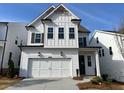Inviting two-story home with a two-car garage, white siding, and meticulously maintained landscaping at 631 Skytop Dr, Cumming, GA 30040