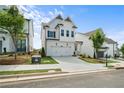 New construction home with white siding, a two-car garage, and manicured landscaping at 631 Skytop Dr, Cumming, GA 30040