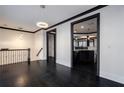 A bright living area with hardwood floors, modern lighting, and a view into the kitchen at 2767 Durham Ne Dr, Atlanta, GA 30319
