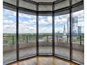 Stunning city skyline and treetop views from the balcony with a stone floor and black railings at 750 Park Ne Ave # 13E, Atlanta, GA 30326