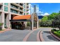 Stately building entrance with covered drive and manicured landscaping at 750 Park Ne Ave # 13E, Atlanta, GA 30326