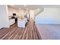 Open-concept kitchen with stainless steel appliances, granite countertops, and a center island at 7744 Sudbury Cir, Covington, GA 30014