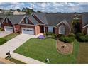 Attractive brick home with an attached garage and a well-maintained, green front yard at 1042 Pecan Grove Pl, Lawrenceville, GA 30046