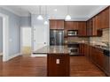 Kitchen featuring granite countertops, wood cabinets, stainless appliances, and hardwood floors at 11 Perimeter E Ctr # 1404, Atlanta, GA 30346
